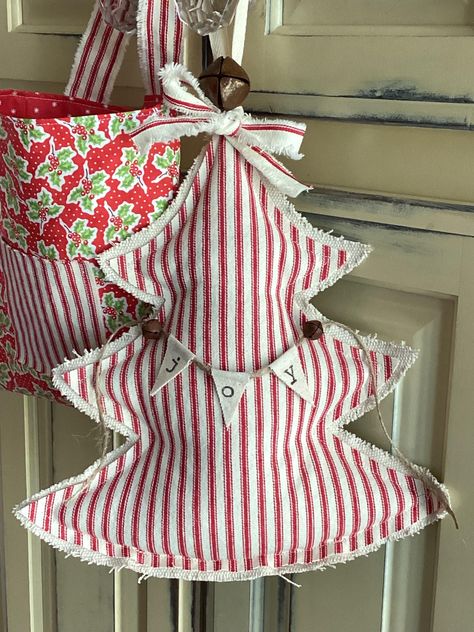 Oh Christmas Tree! Handmade Primitive Farmhouse Christmas Tree! Perfect for hanging on a peg rack, knob, or cupboard. This Red Ticking Stripe Tree is Farmhouse charm at its best! Please check out my shop....I have many festive items in the works for the holidays! Listing is for (1) Large Fabric Christmas Tree Red and Cream ticking stripe with natural grain sack fabric on the backside The tree measures approximately 13"H X 12"W inches (at the widest point)  Generously stuffed with polyester filli Fabric Christmas Trees Stuffed, Swedish Christmas Tree, Christmas Tree Pillows, Primitive Farmhouse Christmas, Diy Farmhouse Christmas Decor, Stuffed Christmas Tree, Beeswax Diy, Fabric Christmas Decorations, Christmas Booth