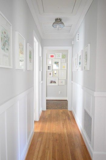 Benjamin Moore Moonshine is a bright panit colour for a dark hallway. Looks good with board and batten, wainscoting and wood flooring by Young House Love Decorating A Narrow Hallway, Lambriseringen Gang, Hallway Paint, Upstairs Hallway, Young House Love, Dekorasi Kamar Tidur, Narrow Hallway, Hus Inspiration, Hallway Decorating