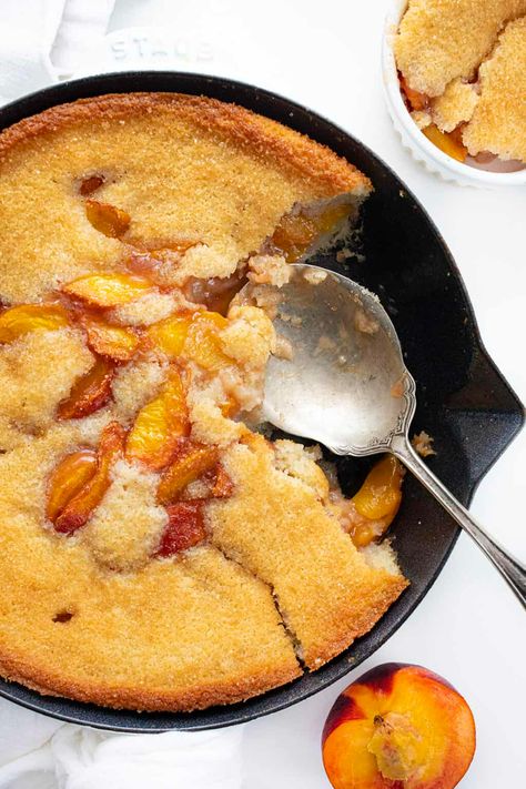 Peach Skillet Cake is a dessert made with sweetened fresh peaches that are poured over a batter mixture and topped with turbinado sugar. Skillet Cake, Peach Cake, Peach Skillet Cake, Skillet Cakes, Peach, Peach Dessert, Dessert, Summer Desserts, BBQ, Baking, i am baker, iambaker Dutch Oven Cobbler, Cracker Barrel Menu, Dutch Oven Peach Cobbler, Brown Sugar Peaches, Skillet Desserts, Peach Bread, Peach Pound Cakes, Baking Lessons, Peach Dump Cake