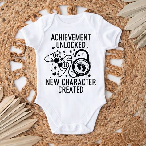 Break the big news of your pregnancy announcement with this perfect baby onesie®. This is a personalized custom pregnancy announcement for the whole family. Onesie® comes in two colors, Black or White and two sizes of your choice. This can be ordered in just the onesie® or you can add the custom box with personalized name and cute note of your choice. The box size is 6x5x2 with shredded colored stuffing for a cute touch to your adorable baby announcement. We use high quality, soft flex vinyl whi Video Game Baby Announcement, Baby Announcement To Coworkers, Player 3 Baby Announcement, Video Game Pregnancy Announcement, Baby Onsies Ideas Announcement, Pokemon Pregnancy Announcement, Nerdy Pregnancy Announcement, Nerdy Baby Announcement, Funny Baby Announcement Ideas