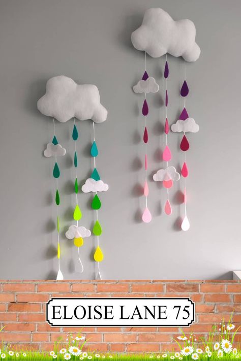 A gorgeous wall hanging that will look perfect in any nursery. The large white fleece cloud with 3 strands each holding of 7 vibrant and pastel coloured raindrops, attached by 3mm white satin ribbon. Cloud Wall Art Nursery, Wall Hanging Ideas For School, Rainbow Hanging Decor, Pompom Design, Cloud Wall Decor, Cloud Decor, Diy Baby Room Decor, Cloud Wall Hanging, Cloud Nursery Decor