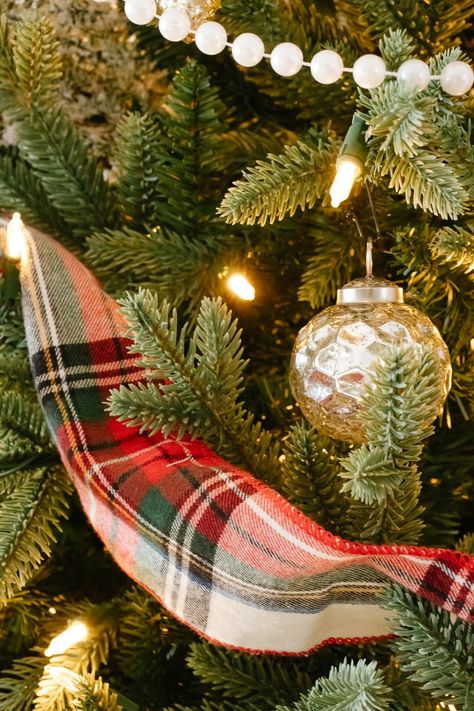 A Christmas tree filled with cozy flannel plaid ribbon, traditional pearl beaded garland and loads of beautiful mercury glass and mixed metal ornaments to create a vintage inspired Christmas tree with a cozy + nostalgic feel for the holidays. #vintagechristmas #christmastree #cozychristmastree #mercuryglass #mercuryglasschristmas #plaidchristmasdecor #nostalgicchristmasdecor #christmastreedecoratingideas Vintage Plaid Christmas Tree, Christmas Trees With Plaid Ribbon, Plaid Christmas Ribbon On Tree, Christmas Tree With Plaid Ribbon, Mixing Plaids For Christmas, Plaid Decorated Christmas Tree, Christmas Tree Plaid Theme, Plaid Ribbon Christmas Tree, Plaid Christmas Tree Ideas