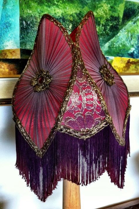 A classic Victorian tulip shade . This shade style started out in the kerosene era , this one  is a recreation of a large antique oversized floor lampshade I have in my collection. The shade has a lining of red silk with pleated purple chiffon over top.  Panels of metallic French gold lace accent the corner panels  , trimmed with antique metallic trim, with Chinese chainet fringe dyed to match the tones of the shade. Jean Couch, Victorian Lamp, Beaded Lamps, Lampshade Makeover, Victorian Lamps, Victorian Lampshades, Creative Textiles, I Love Lamp, Bohemian House