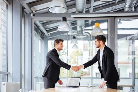 Two happy businessmen standing and shaking hands on business meeting by vadymvdrobot. Two happy successful young businessmen standing and shaking hands on business meeting#shaking, #hands, #standing, #happy Circle Logos Inspiration, Shaking Hands, Architecture People, Corporate Headshots, Shake Hands, Business Photos, Business Meeting, Abstract Photos, Modern Graphic Design