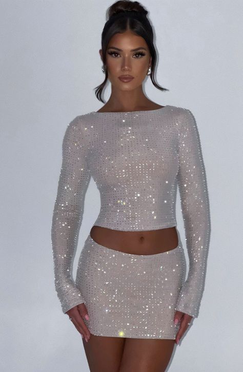 Glow all night in the Tani set. Cut from a sparkly rhinestone mesh that hugs every curve, this long sleeve nude top is cropped with a high neck. Match with the Tani skirt, sleek waves and heels for party season.