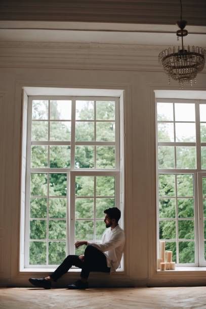 Man Sitting On Window Sill At Home Sitting On Window Sill, Sitting On Window, Window Photography, Window Ledge, Guy Best Friend, Reference Pics, Human Reference, Pose References, Man Sitting