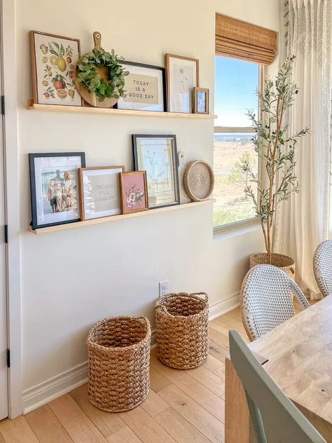 Shelves In Breakfast Nook, How To Style Picture Shelves, Styling A Floating Shelf, Dining Wall Shelves, Open Hallway Decor, Boho Floating Shelf Decor Living Room, Above Tub Decor, Wall With Shelves And Pictures, Family Room Wall Decor Ideas Above Couch