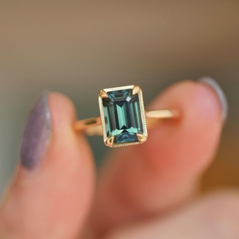 Why are we so obsessed with Teal Sapphire Engagement Rings you ask? High quality natural sapphire gemstones are actually rarer than diamonds, especially in this perfect blue-green teal color. Teal sapphires also have the striking elegance of a traditional sapphire engagement ring, but with a unique twist of color that pops like nothing else. Make a statement of timeless beauty with this stunning one of a kind teal sapphire engagement ring set in our elegant solitaire setting. #engagementrin... Senior Ring, Blue Green Sapphire Ring, Persian Tattoo, Teal Sapphire Engagement Ring, Emerald Engagement Ring Green, Nontraditional Engagement Rings, Rings Sapphire, Boda Ideas, Sapphire Engagement Ring Set