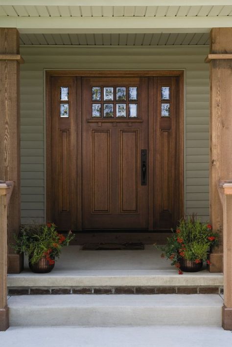 The front door of your home says a lot about who lives inside. But selecting an entry door that fits your home’s style, adds value to your home, and is aesthetically beautiful can be an overwhelming process. Because a front door has the ability to add (or subtract) to our home’s curb appeal as well as safety, replacing it is consistently rated a high-value project for homeowners to invest in. Dark Wooden Front Door, Craftsman Style Exterior Doors, Double Front Doors With Side Lights, Front Doors With Side Lights, Craftsman Front Door, Craftsman Entry, Craftsman Front Doors, Entry Door With Sidelights, Ranch Remodel