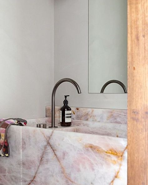 CDK Stone on Instagram: "Rosa Calmante has been used throughout the home of AFLW star Katie Brennan and partner Olivia Christie's with a feature vanity in the bathroom.⁣ Designed by @bergmanandco ⁣⁣ Image by @nataliejeffcott ⁣⁣ ⁣⁣ #cdkstone #rosacalmante #naturalstone #naturalbeauty #naturesmasterpiece #designstyle #natural #stone #interiors #exteriors #designinspo #designinspiration #natural #interiors #stone #interiordecor #designoftheday" Pink Marble Sink, Rose Quartz Bathroom, Pink Marble Bathroom, Bathroom Bench, Natural Interiors, Natural Stone Bathroom, Quartz Bathroom, Stone Bathroom Sink, Stone Vanity