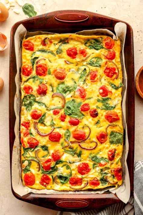 These Sheet Pan Eggs are a breakfast prep dream-come-true! They come together with your favorite veggies, cheeses, and meats to create a hearty egg frittata. Enjoy as-is with your favorite breakfast side dishes or meal prep and make into freezer breakfast sandwiches! Sheet Pan Frittata, Sheet Pan Eggs In The Oven, Sheet Pan Breakfast Sandwiches, Breakfast Side Dishes, Sheet Pan Eggs, Egg Frittata, Breakfast Sides Dishes, Spinach Bake, Breakfast Meat