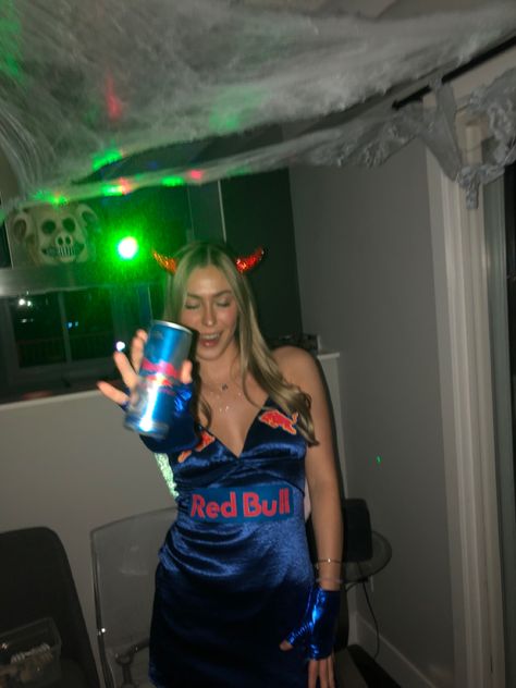 Girl dresses as Red Bull drink with wings on wearing blue shiny gloves and dress angles wings devil horns logo holding redbull drink Vodka Redbull Costume, Halloween Costumes Redbull, Redbull Halloween Costume, Red Bull Halloween Costume, Redbull Costume, Red Bull Costume, Bull Halloween Costume, Halloween Costumes Blue Dress, Redbull Outfits