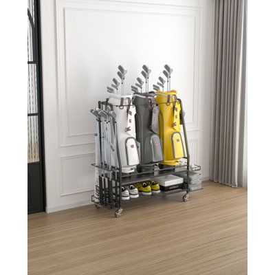 This impressive golf bag storage rack for the garage is a product designed to help organize and store golf bags and accessories in a garage or other storage area. It features 3 standard golf bag spaces, three removable hooks, and additional side storage space for up to eight golf clubs. | Arlmont & Co. Naleya Free-standing Golf Storage Rack for 3 Golf bags Black 42.1 x 51.6 x 16.0 in, Metal | Organization | XONG1007 | Wayfair Canada Golf Bag Organization, Golf Club Storage Garage, Golf Bag Storage, Golf Storage, Home Gym Storage, Guitar Storage, Side Shelves, Outdoor Cabinet, Bag Rack