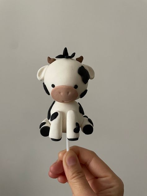 Material: fondant The colors of the topper can be customized. Cow height may vary: 3-4 inches Cow Fondant Tutorial, Two Tier Cow Cake, Fluffy Cow Birthday Cake, 3d Cow Cake, Fondant Cow Topper, Fondant Cow, Cow Clay, Cow Cake Topper, Farm Cake Topper