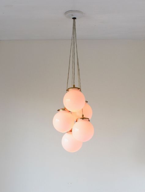 Easy to install, this chandelier goes well with any decor and is ready to add light and charm to your space. Features 5 round white glass globes in a falling cluster.  Shade holders and socket covers are available in brass, matte black or polished nickel and can be chosen upon checkout. (Brass shown in photos) Comes with a ceiling plate attached, all ready for wiring directly into the ceiling. All necessary hardware for installation is included. Ceiling plate is available in white or black and c Cluster Pendant Lighting, Bubble Chandelier, Bubble Lights, Globe Pendant Light, Arm Chandelier, Lighting Decor, Globe Chandelier, Hanging Light Fixtures, Globe Pendant