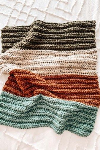 An image of a crochet baby blanket with colour stripes. Green, off white, orange and baby blue on a white bed. First Crochet Blanket, Crochet Blanket For Beginners Tutorials, Crochet Blanket 4 Colors, Crochet Swatch Blanket, 3 Colored Crochet Blanket, Beginner Crochet Baby Blankets, Free Baby Boy Crochet Blanket, Crochet Blanket Patterns Simple, Basic Blanket Crochet Patterns