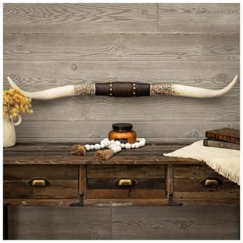 Dimensions: 3.78" H x 40.25" W x 2.44" D Material: Resin Shape: Novelty Color: White, Brown & Gold Pattern: Floral Orientation: Horizontal Includes: 2 Keyhole Slots Quantity: 1 The grit and charm of nature meet in this pair of commanding horns! Longhorn Studded Western Wall Decor is made of resin and is shaped like two long, distressed horns connected at the center by a section that mimics an ornate leather strap. This resin center is embossed with a floral design and metallic gold studs, adding to the horns' country charm. Hang this southwestern beauty in the living room of your ranch house as a rustic statement.   Note: Some assembly is required. Modern Ranch House Decor, Cow Hide Wall Decor Ideas, Large Picture Wall Ideas, Western Living Room Ranch Style, Longhorn Skull Decor, Western Office Decor, Ranch Style Decor, Rustic Office Decor, Cow Skull Decor