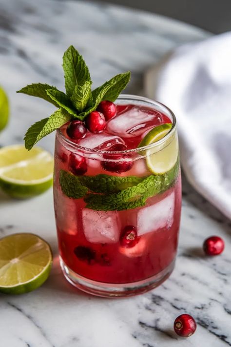 A photo of a  Cranberry Mojito a Cranberry Cocktails Cranberry Mint Cocktail, Cranberry Non Alcoholic Drinks, Cranberry Mojito Recipe, Festive Mojito, Holiday Mojito, Cranberry Juice Cocktails, Cranberry Mojito, Cranberry Cocktails, Cranberry Cocktail Recipe