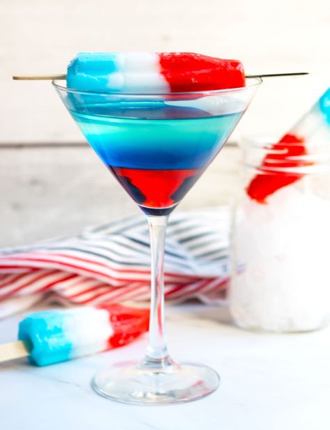 This Bomb Pop Martini has layers of red, white and blue that make a perfect martini for the 4th of  July or Memorial Day.  The fun, patriotic appearance is achieved with Bacardi Limon with pineapple juice, Blue Curacao and Grenadine. Red White Blue Martini, Bomb Pop Mimosa Recipe, 4th Of July Martini, Bomb Pop Alcoholic Drinks, Bomb Pop Shot, 2023 Cocktails, Creamsicle Mimosa, Crescent Roll Pastry, Summer Martinis