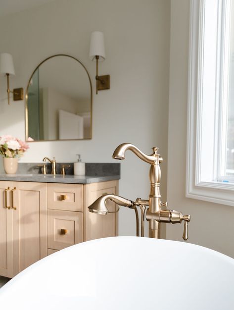 Champagne bronze details like the shower handle, hinges, and floor-mounted tub filler add an elegant touch. Champagne Bronze Bathroom, Herringbone Tile Floors, French Villa, Bronze Bathroom, Herringbone Tile, Champagne Bronze, Tile Floors, Bathroom Inspo, Tub Filler