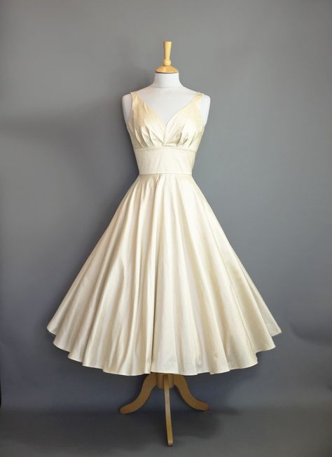 "A romantic and understated 1950's style wedding dress made from a Champagne Silk Dupion with a tea length skirt, perfect for wearing with a layered petticoat for ultimate swish and maximum volume. The fitted waistband creates a fantastic silhouette which echoes the tailored shape of the 50's which is followed through in the full circle skirt. Photographed here with a Swing petticoat underneath for the fuller shape.  Ready to ship NOW This dress is ready made and available off-the-peg in a size Forest Wedding Dress, Dig For Victory, 1950s Wedding Dress, Tea Length Skirt, Winter Formal Dresses, Wedding Dress Champagne, Full Circle Skirt, Full Circle Skirts, Ivory Dresses