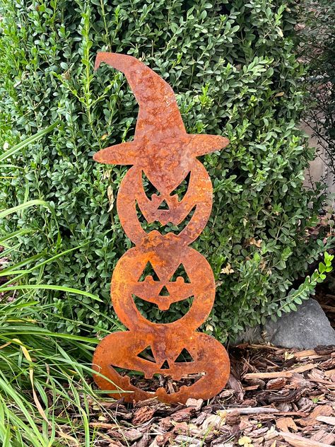 "Halloween Pumpkin Rustic Yard Decor perfect for Halloween and Fall season decoration and beyond. This metal stacked pumpkin design with witches hat is so perfect for outside decorating. Steel metal allows this decoration to last year after year!  Pumpkin Measures: 23\" x 9.5\"  Stakes: 3\" approximately  H3 Metal Designs is a family owned business located in Idaho that creates and cuts metal projects, large and small. We can design personalized custom projects or you can shop our already made i Metal Fall Yard Art, Fall Metal Art, Halloween Metal Art, Pumpkin Yard Decor, Rustic Yard Decor, Sheet Metal Crafts, Rustic Halloween Decor, Halloween Yard Art, Metal Welding Art