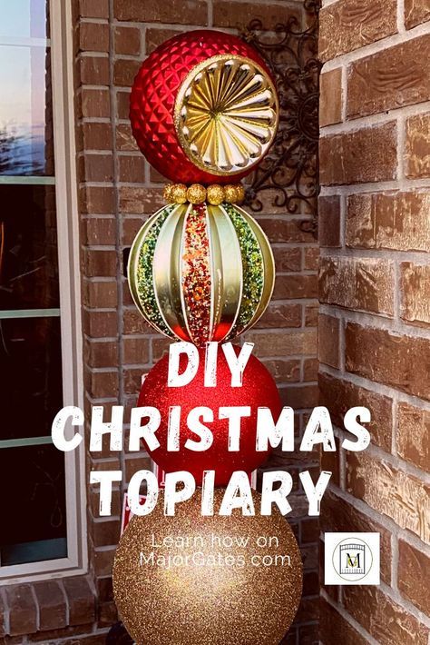 Diy Stacked Christmas Ornaments, Ornament Topiary Diy Front Doors, Large Hanging Christmas Decorations, Xmas Topiary Ideas, Christmas Topiary Outdoor Diy, Large Front Porch Christmas Decor, Christmas Ornament Topiary Diy, Christmas Tree In A Planter, Diy Large Ornaments For Tree