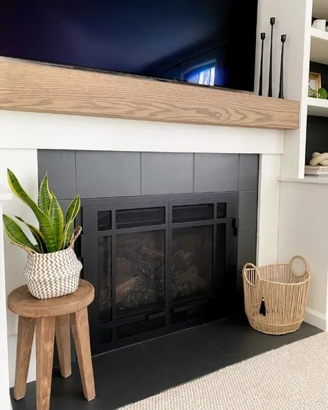 As part of this fireplace makeover, learn how to make a mantel and paint tiles to update the look of your fireplace. No Tile Fireplace, Diy Fireplace Makeover Rental, Fireplace Surrounds And Mantels Tile, Townhouse Fireplace Makeover, Basic Tile Fireplace, Tile Around Fireplace Ideas Mid Century, Diy Rental Friendly Fireplace, Diy Fireplace Refacing, Shiplap Over Tile Fireplace