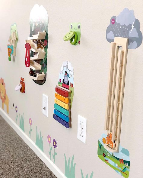 Keep the toys off the floor with toys that go on the wall! No more messes around the nursery playrooms! Toys On The Wall, Nursery Sensory Wall, Playroom Wall Activities, Interactive Playroom Wall, Interactive Wall For Kids, Playroom Wall Ideas, Activity Wall, Wall Toys, Micro Creche