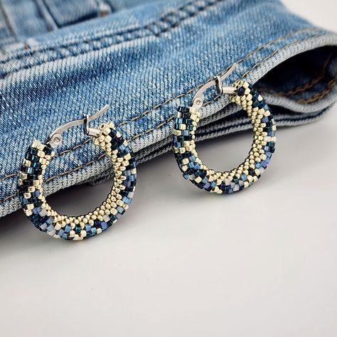 Denim Beaded Hoop Earrings Mesmerizing Light-Reflecting Effect      Looking for earrings that match perfectly with your favorite jeans or jean jacket? These denim beaded hoop earrings are created especially for denim lovers. Made with unique silk satin beads, they shine beautifully and reflect light from different angles, creating a captivating effect. Crafted using six types of beads to mimic denim fabric but with varied textures, these earrings look even better in person, with a fantastic shin Abstract Beaded Earrings, Seed Bead Jewelry Tutorials, Shiny Earrings, Multicolor Earrings, Pad Bag, Beaded Jewelry Patterns, Beaded Hoop Earrings, Beaded Hoops, Fun Fashion