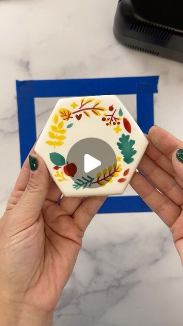 The Cookie Countess on Instagram: "2 other important tips I wanted to point out… 1️⃣ When you are using a multi-piece stencil on multiple cookies, that have a shape like this one, where you could possibly forget which side is the top… when moving your cookies back and forth to your airbrush area, place your cookies in a way that you won’t forget which side is the top, so your next stencil pieces will line up properly.  2️⃣Using the flat side of the Thingamagenie is a great way to hold your stencil tight to your cookie as you airbrush. Especially if your cookies slope down a bit as the flood icing gets to the sides. 🥳 And how pretty is this wreath?? 🍁" Flood Icing, Cookie Countess, The Flood, Hold You, Sugar Cookies, Hold On, Wreath, Instagram