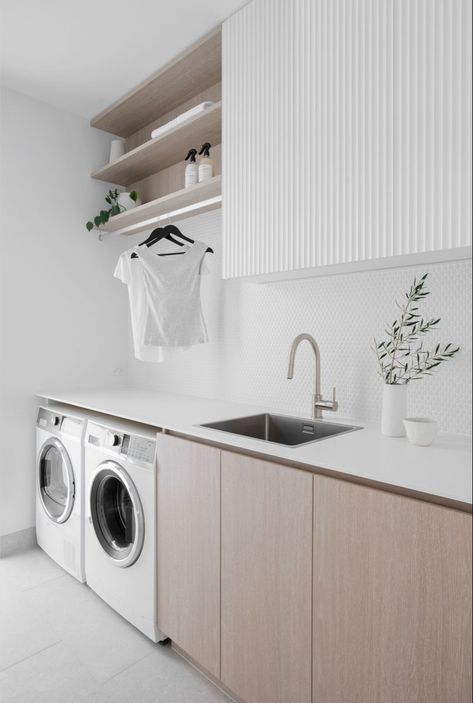 Classic finishes were used to create this Coastal Laundry Room, including White panelled overhead cupboards and benchtop, paired with Oak cabinetry and open shelves. Brushed nickel mixer tap and white penny round tiles complete the look. Follow us on Instagram and Pinterest for all the latest home design, tips, trends and products. #laundry #laundryroomideas #laundryroomdesign #pennyrounds #whitekitchenideas #shelves #paneling #oakkitchencabinets Laundry Makeover, Dream Laundry Room, Laundry Room Layouts, Laundry Room Renovation, Laundry Design, Modern Laundry Rooms, Laundry Room Remodel, Laundry Room Inspiration, Contemporary Coastal