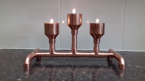 Hand made copper Tea light holders made out of brand new pipes and fittings. The idea for this variation came from my daughter who's an artist. Tealight holders are varnished/lacquered for longevity and to keep from tarnishing. (candles not included) Dimensions -   Height -150mm (tallest tea light holder)                           Width - 130mm                          Long - 260mm  All sizes are approximate I have been a plumber for over 25 years and decided to use my knowledge to create new fu Copper Pipe Candle Holder, Copper Ideas, Copper Floor, Pipes And Fittings, Copper Crafts, Copper Decor, Copper Diy, Tea Light Holders, Light Copper