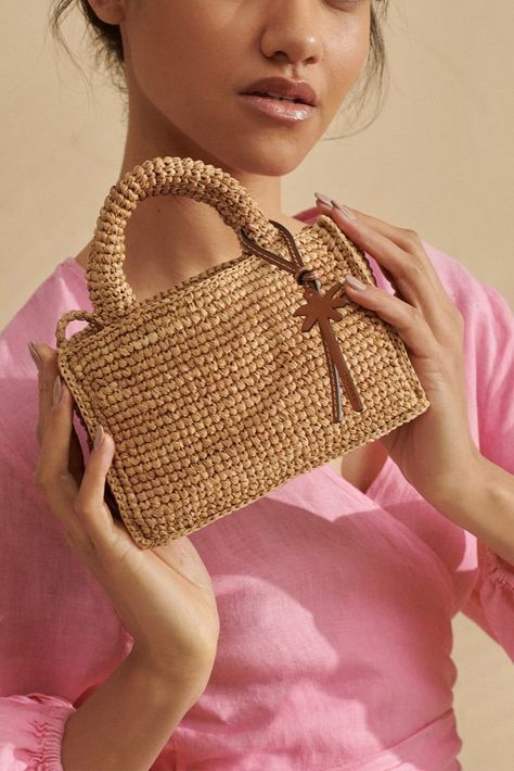 Add a touch of summer to your wardrobe with the Sunset Bag Mini in Tan by Manebí. Handmade from raffia with an iconic Manebí palm tree leather tag, this chic accessory is perfect for any summertime look. With a shoulder strap also made from raffia, this bag is both stylish and functional. The sunset mini bag comes with an exclusive cotton dust bag, featuring the Manebí­ palm and logo. Composition: 100% raffiaMeasurements: 18 cm (length) x 11 cm (height) x 6 cm (depth)Handle: 6 cmMax strap length Rafia Bags, Crochet Raffia Bag, Crochet Mini Bag, Raffia Crochet, Logo Composition, Branded Outfits, Crochet Fairy, Heel Accessories, Crochet Handbags Patterns