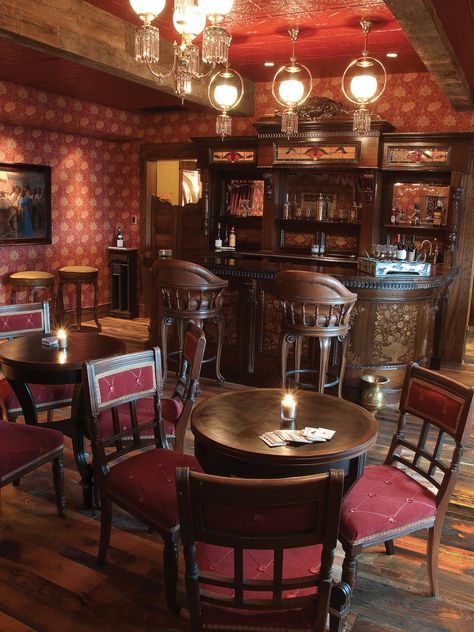 The D and D Saloon boasts a vintage bar. Burnt red keeps with the Old West theme. The custom back of the bar is fitted with a hidden karaoke screen to help struggling singers. Barn Bar, Saloon Bar, Saloon Decor, Old West Saloon, Victorian Bar, Western Bar, Western Interior, Western Saloon, العصور الوسطى