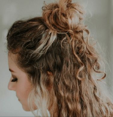 35 Best Half-Up Bun Hairstyles That Don't Look Messy | YourTango Half Up Hairstyles Wavy Hair, Half Up Bun Curly Hair, Curly Half Up Half Down Bun, Half Up Half Down Bun Curly Hair, Half Up Curly Hairstyles, Curly Hair Bun Styles, Messy Bun Curly Hair, Half Up Messy Bun, Half Bun Hairstyle