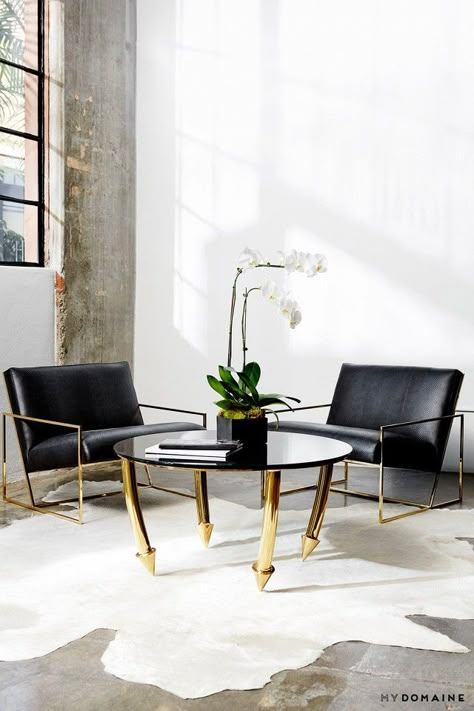 An office lobby, with a dramatic bespoke gold coffee table, a cowhide rug, and black armchairs Waiting Room Design, Aimee Song, Office Lobby, Gold Coffee, Gold Coffee Table, Lobby Design, Waiting Area, Cowhide Rug, Trendy Home