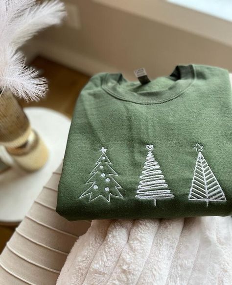 Embroidered Christmas Tree Sweatshirt Hoodies, Christmas Crewneck, Trendy Winter Sweater, Faith based apparel, Unisex Pullover, Holiday Gift 💕WELCOME TO Love Stitches Co If you are looking for soft, comfy, first-rate sweatshirts, you're in the right place! Here at Love Stitches Co, we love what we do and strive to make your shopping experience just right for you. If you have any questions, concerns, or comments about our products, feel free to shoot us a message anytime. Even on weekends and holidays, we'll try our best to respond as quickly as possible! Product Details Unisex Sweatshirts: - Gildan Brand -50% cotton - Light/medium weight and soft, this sweatshirt is sure to be your next favorite sweatshirt. 💕Sizing and Coloring Please make sure you select the right color and size for you Winter Embroidery Sweatshirt, Embroidered Christmas Sweatshirt, Patch Sweatshirt Diy, Hand Embroidery Sweatshirt, Christmas Sweater Ideas, Embroidery Apparel, Embroidered Christmas Tree, Winter Embroidery, Christmas Tree Sweater