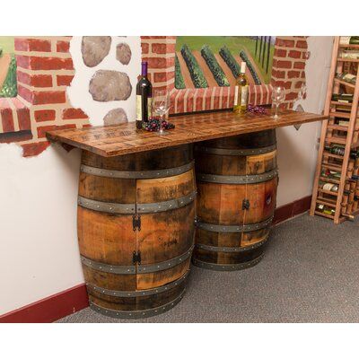 This brilliant piece gives you the appeal of two real whole retired wine barrels in a smart space saving design. Use as a bar or sideboard. It offers ample storage with two half barrel cabinets with one interior shelf each and a bar top made from weathered solid white oak with a distressed finish. | Fleur De Lis Living Upham Double Half Barrel Pub Table Wood in Brown/Green, Size 36.0 H x 65.0 W x 18.0 D in | Wayfair | Black Friday / Cyber Monday Deals Wine Barrel Wall, Whiskey Barrel Bar, Wine Barrel Bar, Wine Barrel Table, Wood Barrel, Wine Barrel Furniture, Barrel Decor, Barrel Bar, Barrel Table