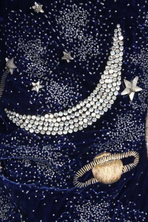 This is arguably one of the most beautiful of all Schiaparelli's creations with its glittering embroidery, shimmering star-shaped beads and rhinestones set against a midnight blue velvet ground. It would have been worn over a matching bias-cut evening gown. Marlene Dietrich, a huge fan and client of Schiaparelli, was photographed in her Beverly Hills residence in 1938 wearing the zodiac ensemble with matching dress. The jacket sold at auction in 2013 for £110,000. Embroidered Planets, Schiaparelli Couture, Midnight Blue Dress, Moon Fashion, Party World, Elsa Schiaparelli, Star Embroidery, Blue Embroidery, Fabric Beads