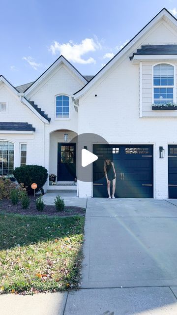 Lauren Jansen | DIY on Instagram: "I did it!! I painted the garage doors black and… I LOVE THEM. I didn’t think I would honestly. I thought it would be too much for this home. But I think they ground and balance the house in such a nice way. The copper hardware doesn’t hurt either 🤌 oh and painting them wasn’t hard at all! Here’s how I did it… I started by removing the old hardware, cleaning the doors, and taping around the trim. Then I used a bonding primer (zinsser bondz) before applying two coats of Sherwin Williams Everlast paint in Tricorn Black with a flat finish. Make sure you remove the tape while the paint is still wet and raise the garage doors halfway for the paint to dry without the panels sticking together. I also scraped my windows clean with a razor blade instead of tap Black Garage Door With Gold Hardware, Front Door And Garage Door Ideas, White House Black Trim Brown Garage Door, Garage Painted Black, White Houses With Black Garage Doors, Garage Door Makeover Black, Iron Ore Sherwin Williams Garage Door, White House Grey Garage Door, Tricorn Black Garage Door