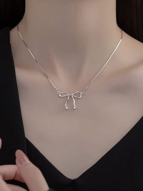 coquette BOW NECKLACE ✨ You are art.. We just accessorize it! Meet DAPHNE Dainty silver snake chain necklace with a perfect bow pendant. Layers wonderfully in a collection or beautiful as a stand alone piece! High quality fine art jewelry made from recycled materials when available Pure 925 sterling silver with 18k gold plating Chain Length 16 inch (40cm + 5cm) Care instructions: To maintain the beauty of your items please remove items before exercising, swimming and showering. It is recommended Cute Jewelry Necklaces Silver, Cute Silver Accessories, Bow Necklace Aesthetic, Silver Cute Jewelry, Cute Necklace Silver, Silver Girly Jewelry, Silver Jewelry Aesthetic Elegant, Silver Bow Jewelry, Cute Silver Necklace