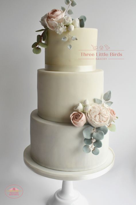 Beautiful three-tier wedding cake at @nterhweddings, West Yorkshire, with soft pastel David Austin roses and garden roses, greenery and eucalyptus. Three Little Birds Bakery, based in Yorkshire, provides luxury bespoke cakes and macaron towers for weddings, birthdays and special occasions, from sugar flower extravaganzas to simple drop cakes and superhero themed birthday cakes. #weddingcake #bespokeweddingcake #barnwedding Wedding Cake Eucalyptus, Sugar Flower Wedding Cake, Drop Cake, Yorkshire Wedding, Wedding Cake Roses, Traditional Wedding Cake, Luxury Wedding Cake, Themed Birthday Cakes