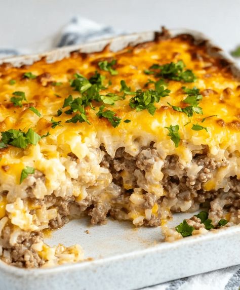 Easy Hamburger Rice Casserole combines ground beef, rice, veggies, and creamy soups for a hearty, family-friendly meal in under an hour. Ground Beef Family Recipes, Cauliflower Rice And Ground Beef, Hamburger Rice Vegetable Casserole, Brown Rice And Hamburger Recipes, Hamburger And Minute Rice Recipes, Hamburger And Cauliflower Rice Recipes, Ground Beef Broccoli Rice Casserole, Beef Rice Soup Recipes, Hamburg And Rice Recipes