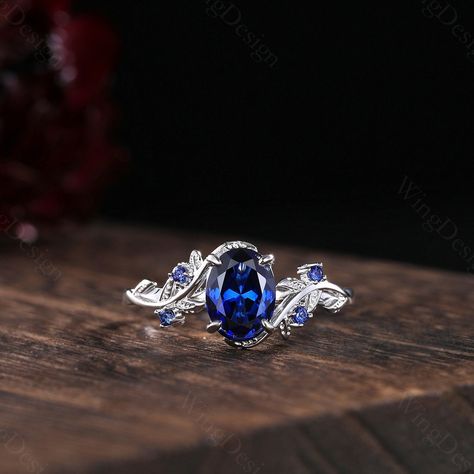 Oval cut blue sapphire engagement ring women silver gold ring unique art deco leaf ring nature branch ring September birthstone promise gift -----Ring Information----- Metal Type: 925 sterling silver, 10K/14K/18K Solid Gold, Platinum Center stone: Lab blue sapphire Stone size: 6x8mm oval shaped Side stone: Blue sapphire (contact me if you need other stones) ✦ Please feel free to contact me if you have any questions or you are interested in custom order. ✦Our Service: Custom Order All Sizes Engra Silver Sapphire Engagement Rings, Engagement Rings Silver Sapphire, Wedding Rings With Sapphires, Silver Sapphire Engagement Ring, Saphire Engament Ring Set Silver, Sapphire Engagement Ring Silver, Blue Stone Engagement Ring, Sapphire Rings Engagement, Unique Sapphire Rings