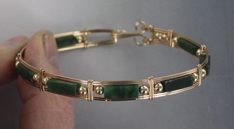 ELEGANT HIGH FASHION GREEN JADE  GEMSTONE BANGLE BRACELET IN  14kt rolled gold  THESE ARE ROUND TUBULAR STONES  HANDCRAFTED IN 14kt rolled gold  IN A UNIQUELY DESIGNED SETTING UNIQUE HANDCRAFTED PIECE THAT WILL GET YOU NOTICED! LIGHTWEIGHT AND EASY TO WEAR SIZE ----- SIZE 6 TO 8 BRACELET IS  1/2 WIDE iTS COMFORTABLE HEAVY DUTY HOOK AND CATCH MAKES IT EASY TO TAKE ON AND OFF AN EYE CATCHING PIECE! WEAR IT CASUAL OR FORMAL OUR GEMSTONES ARE AAA HIGH GRADE  JADE ABOUT MY JEWELRY This is wire sculpt Gold And Jade Bracelet, Green Jewelry Gold, Bracelet En Or, Gold Bangles With Stones, Green Jewelry Aesthetic, Gold And Green Jewelry, Green And Gold Jewelry, Jade Jewelry Design, Elegant High Fashion