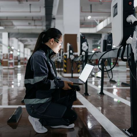 Asian female engineer installing charging station in parking lot Journeyman Electrician, Engineer Girl, Female Engineer, Student Survey, Hard Working Women, Ev Chargers, Automotive Engineering, Carroll Shelby, Forced Labor