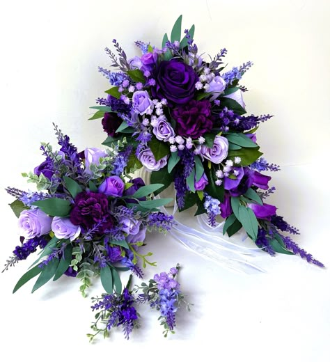 Bridal teardrop bouquet 45 cm long and 27 cm across . Finish with white ribbons  Bridesmaids bouquet 23 cm across , finish with purple ribbon We have two styles of buttonhole available . Purple Bridal Bouquet Real Flowers, Blue Purple Bouquet Wedding, Wedding Flowers Purple And White, Purple Woodsy Wedding, Green And Purple Fall Wedding, Purple Grey Wedding, Purple And White Bouquet, Purple Bride Bouquet, Wedding Bouquet Purple