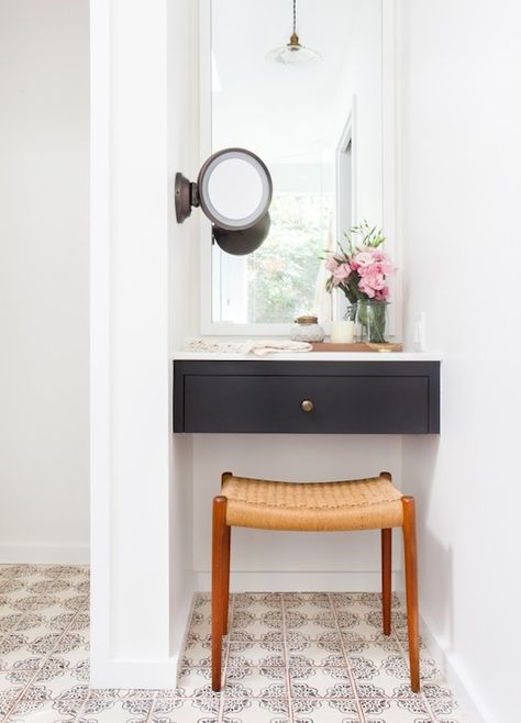 Gorgeous vanity nook features a black floating dressing table with white mirror above, and wall mount make-up mirror to the right, over a mid-century modern teak vanity stool atop hand painted terracotta floor tiles. Amber Interiors Bathroom, Vanity Nook, Bathroom With Makeup Vanity, Desks For Small Spaces, Bright Homes, Room Deco, Amber Interiors, Hus Inspiration, Small Desk