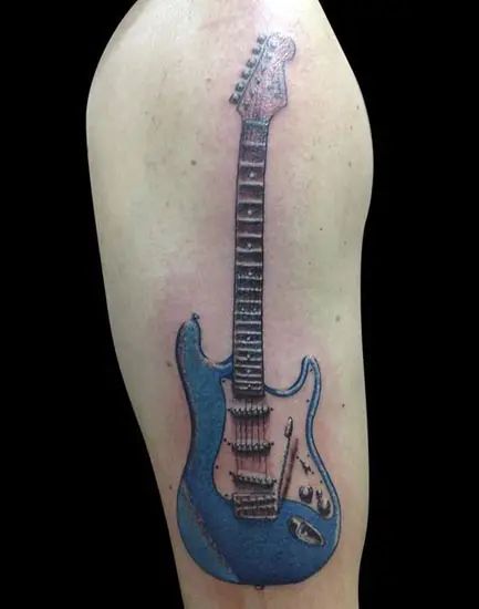 15 Best Guitar Tattoo Designs with Meanings For Girls & Guys Guitar Tattoo For Men, Ty Tattoo, Electric Guitar Tattoo, Tattoos Guitar, Joel Tattoo, Guitar Tattoos, Guitar Pictures, Guitar Tattoo Design, Music Institute